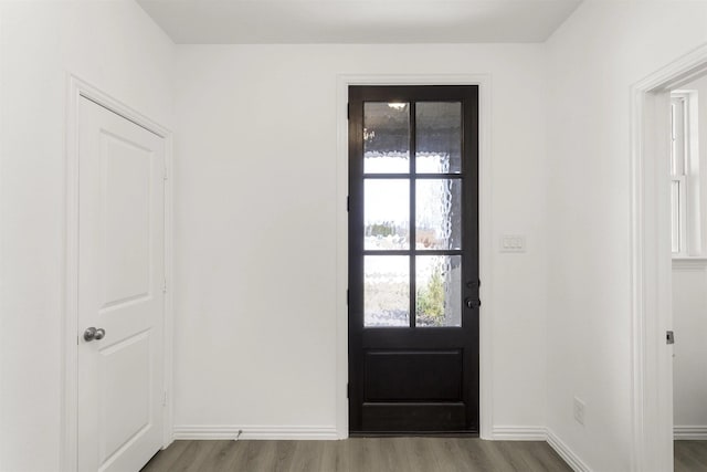 entryway featuring wood finished floors and baseboards