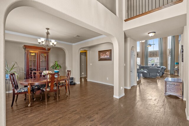 1321 Spanish Needle Trl, Fort Worth, TX 76177 - dining room with arched walkways, baseboards, ornamental molding, and dark wood finished floors