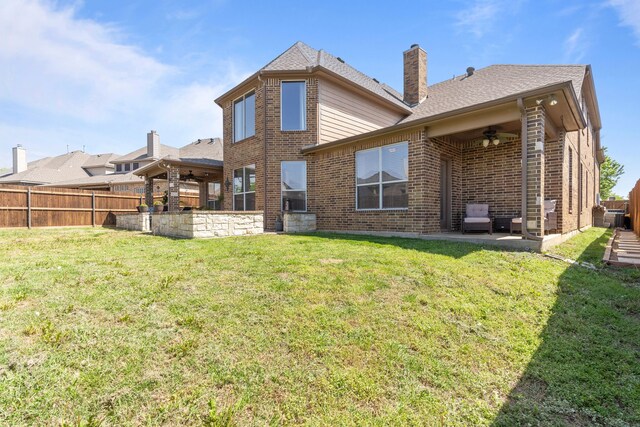 1321 Spanish Needle Trl, Fort Worth, TX 76177 - back of house featuring a yard, a patio area, ceiling fan, fence, and brick siding
