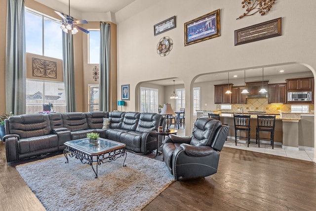 1321 Spanish Needle Trl, Fort Worth, TX 76177 - living area with ceiling fan, light wood-style floors, arched walkways, and a towering ceiling