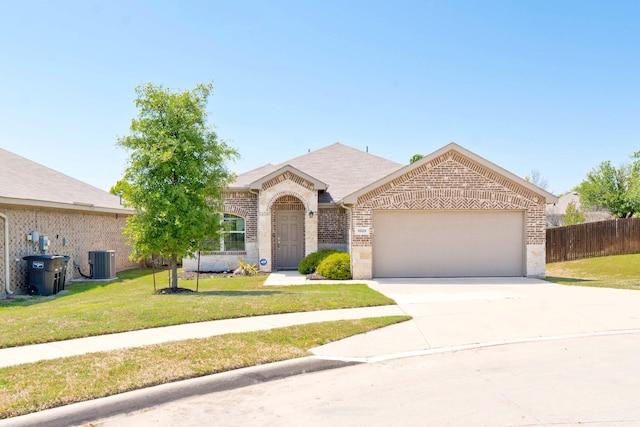 single story home with concrete driveway, brick siding, a front yard, and a garage