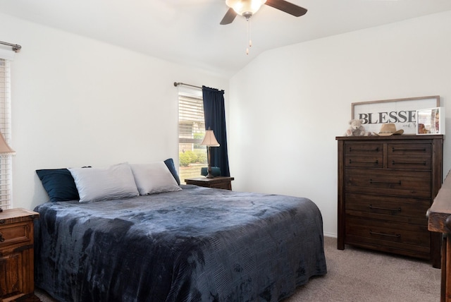 carpeted bedroom featuring lofted ceiling and a ceiling fan