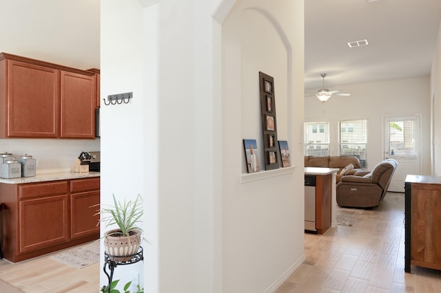corridor featuring arched walkways and visible vents