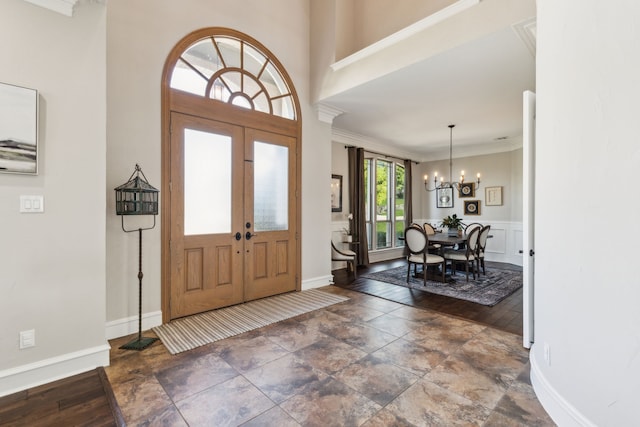 2413 Versailles Dr, Heath, TX 75032 - entrance foyer featuring a chandelier, crown molding, baseboards, and stone finish floors
