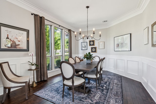 2413 Versailles Dr, Heath, TX 75032 - dining space with healthy amount of natural light, dark wood-style flooring, a chandelier, ornamental molding, and a wainscoted wall