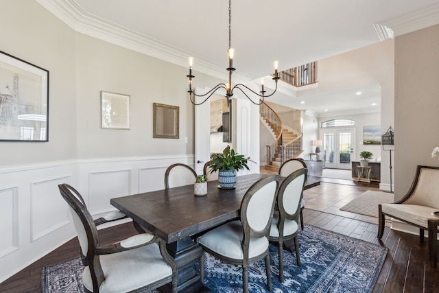 2413 Versailles Dr, Heath, TX 75032 - dining room with stairs, crown molding, wainscoting, wood-type flooring, and a decorative wall