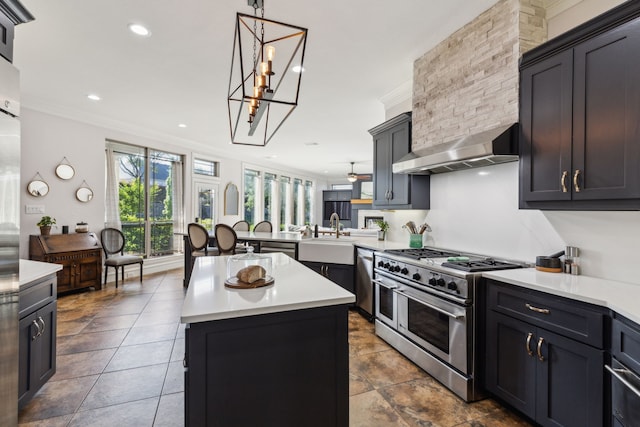 2413 Versailles Dr, Heath, TX 75032 - kitchen with appliances with stainless steel finishes, a sink, wall chimney exhaust hood, ornamental molding, and light countertops