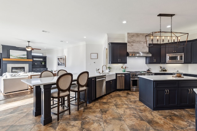 2413 Versailles Dr, Heath, TX 75032 - kitchen with appliances with stainless steel finishes, a sink, crown molding, light countertops, and a peninsula