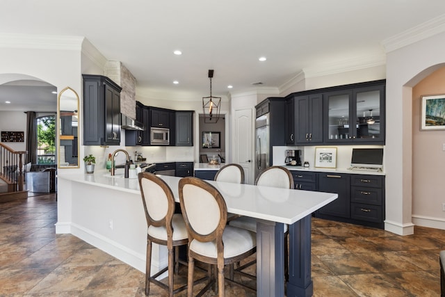 2413 Versailles Dr, Heath, TX 75032 - kitchen with built in appliances, arched walkways, dark stone finish flooring, a kitchen bar, and crown molding