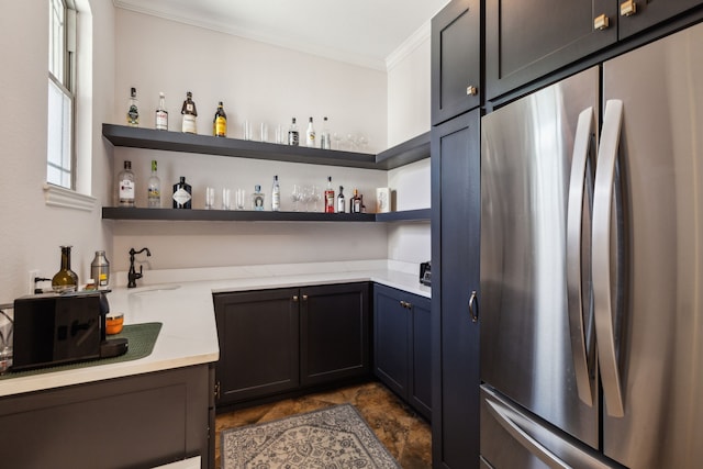 2413 Versailles Dr, Heath, TX 75032 - indoor wet bar featuring stainless steel refrigerator, ornamental molding, and dark stone finish floors