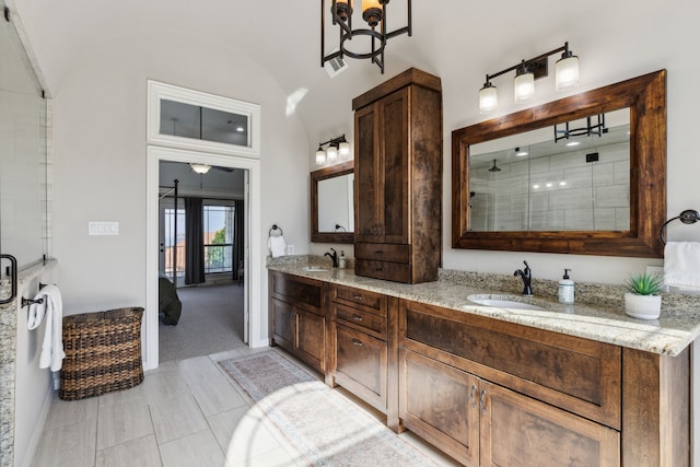 2413 Versailles Dr, Heath, TX 75032 - full bath featuring lofted ceiling, double vanity, and a tile shower