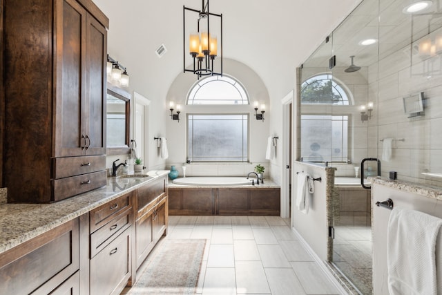 2413 Versailles Dr, Heath, TX 75032 - bathroom with a garden tub, a stall shower, vanity, and a chandelier