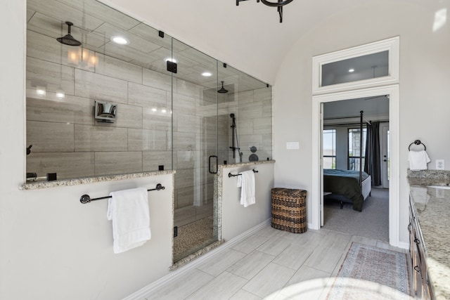 2413 Versailles Dr, Heath, TX 75032 - ensuite bathroom featuring baseboards, a shower stall, and vaulted ceiling