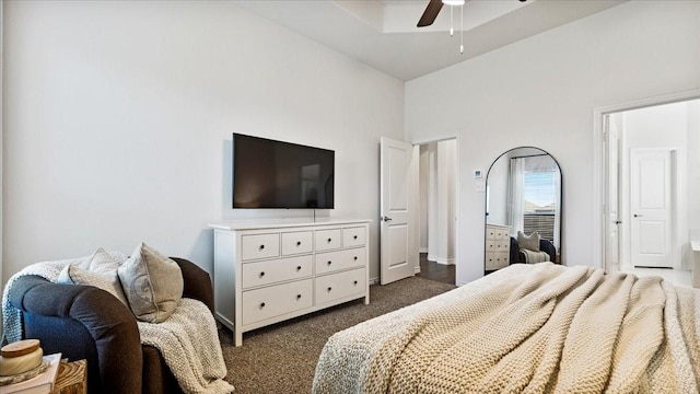 bedroom with dark carpet, ceiling fan, and high vaulted ceiling