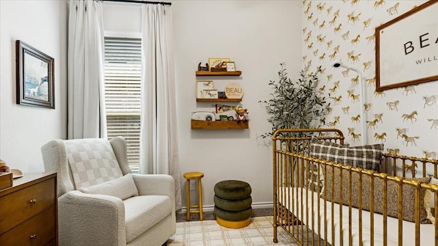 sitting room with tile patterned floors, baseboards, and wallpapered walls