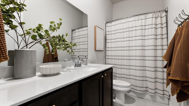 bathroom with toilet, a shower with shower curtain, vanity, and tile patterned floors