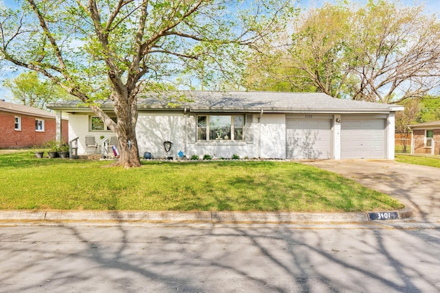 ranch-style house with brick siding, driveway, a garage, and a front yard