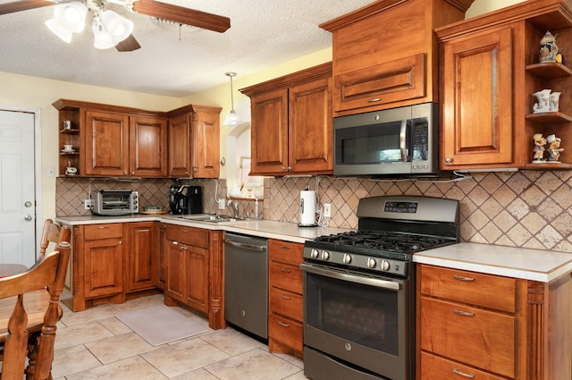 kitchen with open shelves, a sink, light countertops, ceiling fan, and stainless steel appliances