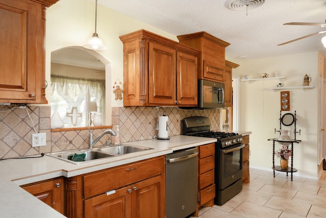 kitchen with ceiling fan, visible vents, appliances with stainless steel finishes, light countertops, and a sink