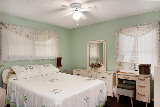 bedroom with a textured ceiling and ceiling fan