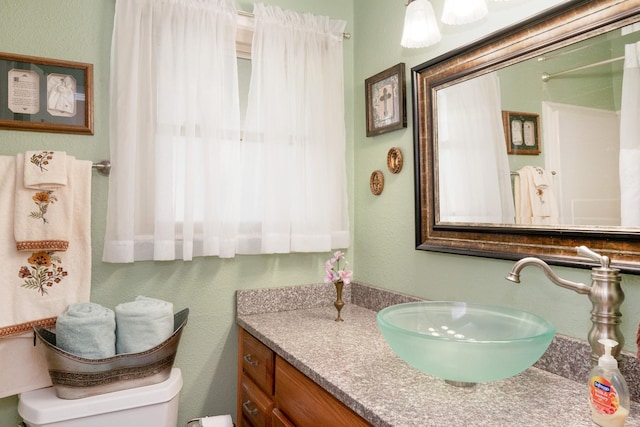 bathroom featuring vanity and toilet