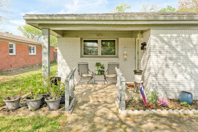 property entrance with brick siding