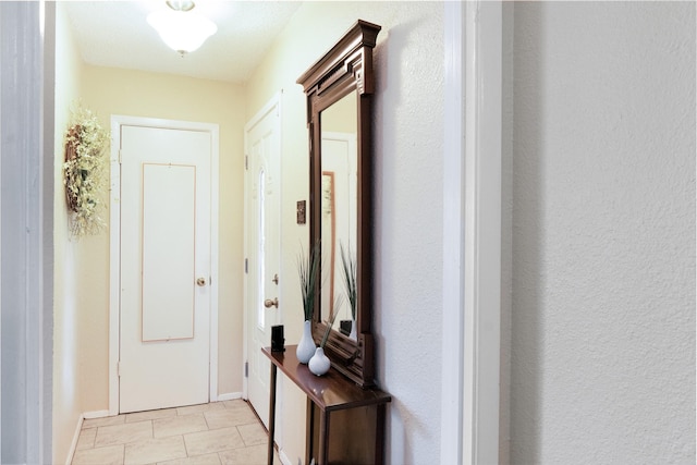 doorway to outside with baseboards