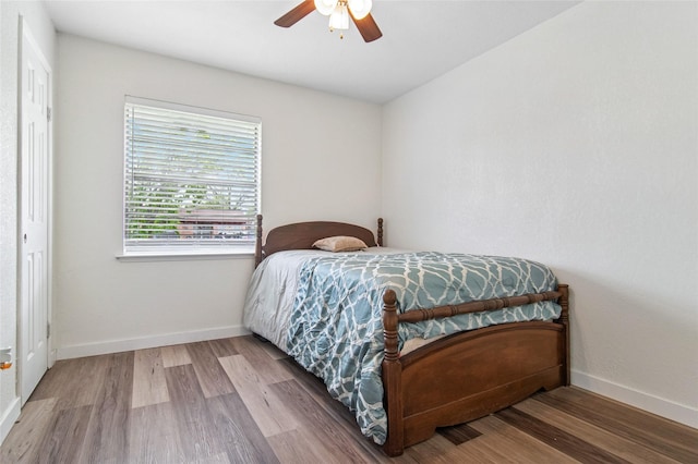 bedroom featuring wood finished floors, ceiling fan, and baseboards