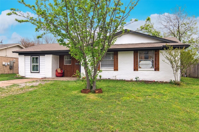 single story home featuring brick siding, a front lawn, and fence