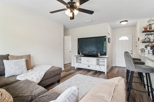 living room with dark wood-style flooring and a ceiling fan
