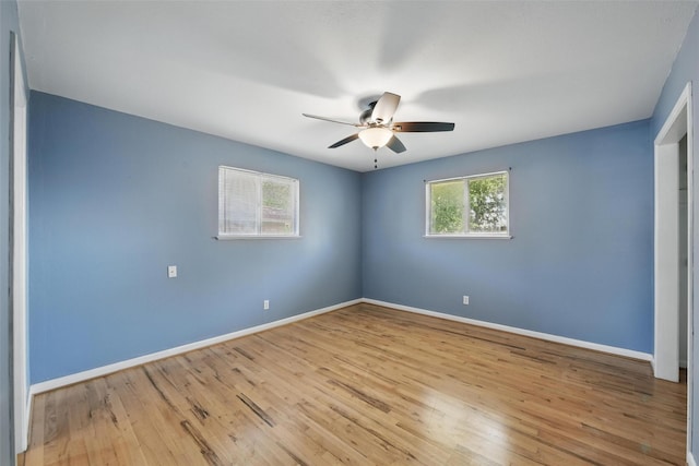 unfurnished bedroom with wood finished floors and baseboards