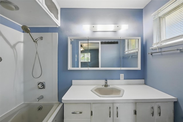 bathroom featuring shower / tub combination, vanity, and plenty of natural light