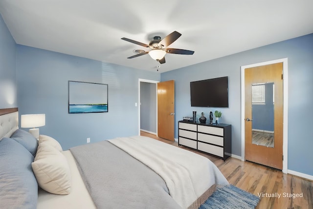 bedroom featuring a ceiling fan, wood finished floors, and baseboards