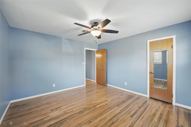 interior space featuring baseboards, wood finished floors, and a ceiling fan