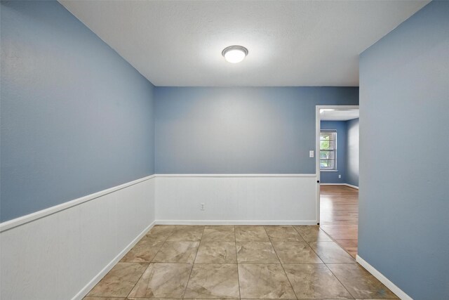 spare room with baseboards