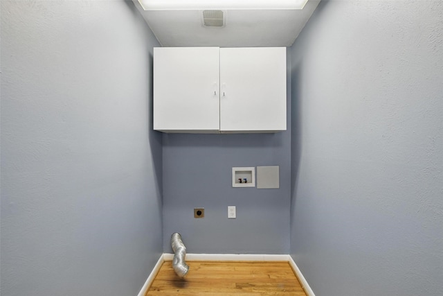 laundry room with baseboards, wood finished floors, cabinet space, and hookup for an electric dryer