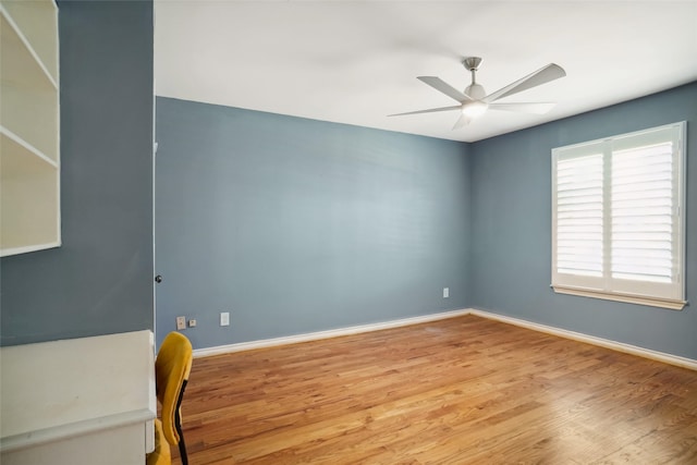 2833 S Country Club Rd, Garland, TX 75043 - empty room featuring wood finished floors, ceiling fan, and baseboards
