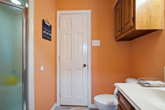 2833 S Country Club Rd, Garland, TX 75043 - bathroom featuring toilet, an enclosed shower, vanity, and baseboards
