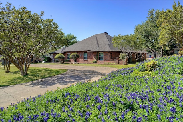 2833 S Country Club Rd, Garland, TX 75043 - ranch-style house featuring roof with shingles, concrete driveway, a front lawn, and brick siding