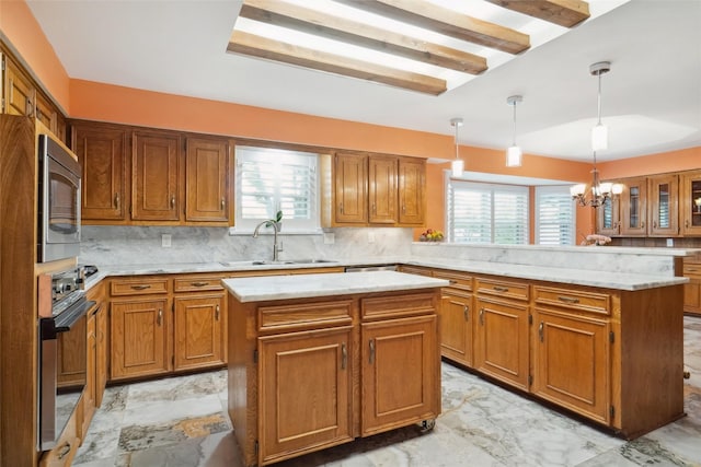 2833 S Country Club Rd, Garland, TX 75043 - kitchen with a peninsula, appliances with stainless steel finishes, marble finish floor, a sink, and brown cabinets