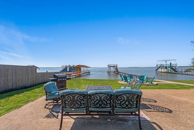 view of patio featuring a dock, boat lift, and a water view