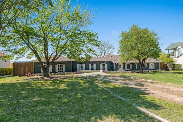 back of house with a lawn and fence