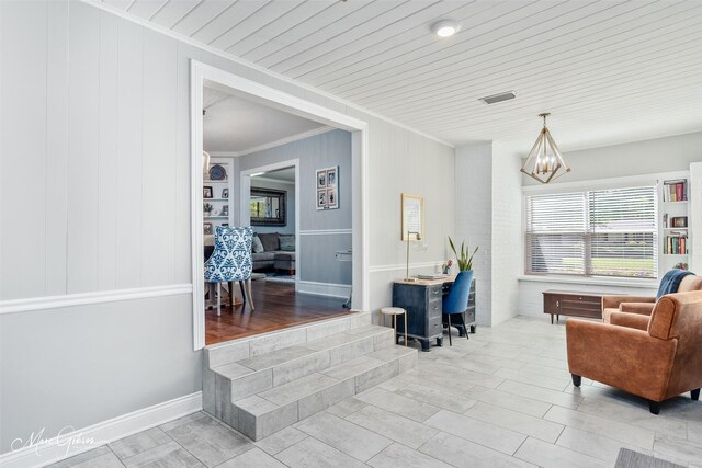 sitting room featuring crown molding, an inviting chandelier, and wood ceiling