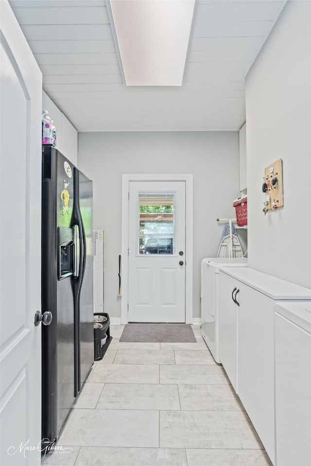 laundry room with laundry area, washing machine and clothes dryer, and light wood-type flooring