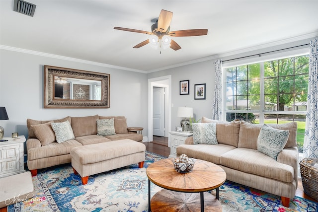 living room with visible vents, a ceiling fan, ornamental molding, and wood finished floors