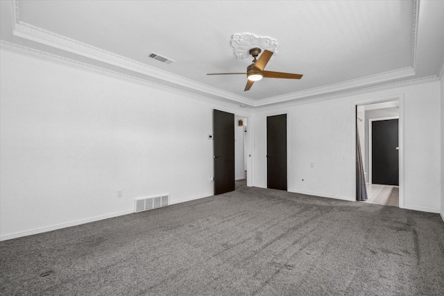 unfurnished bedroom with carpet, visible vents, and ornamental molding
