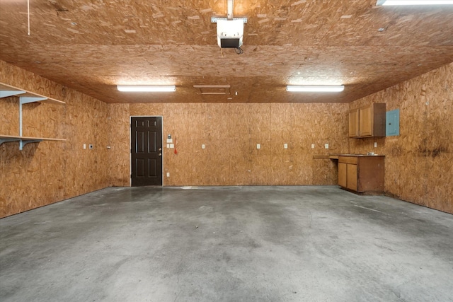 garage featuring electric panel and a garage door opener
