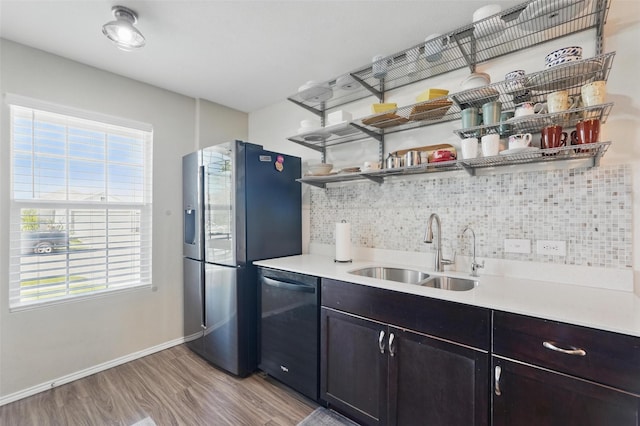 5540 Mcclelland St, Forney, TX 75126 - kitchen featuring dishwashing machine, a sink, tasteful backsplash, open shelves, and light wood finished floors