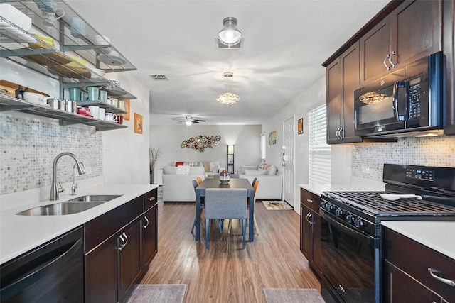 5540 Mcclelland St, Forney, TX 75126 - kitchen with black appliances, a sink, backsplash, and open shelves