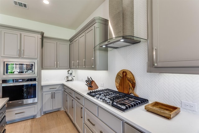 2313 Sandlin Dr, Fort Worth, TX 76008 - kitchen featuring wall chimney range hood, visible vents, appliances with stainless steel finishes, light countertops, and gray cabinetry